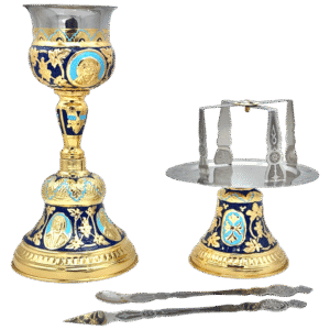 Ornate ecclesiastical liturgical items including a gold and blue decorated chalice, silver incense boat, and a spoon, used for religious ceremonies at Tsatsaronis Antoniou church supplies store.