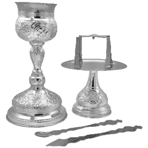 Intricately designed silver Orthodox Christian liturgical items for church services, including a chalice, altar plate, and spoon, perfect for religious ceremonies and ecclesiastical use.