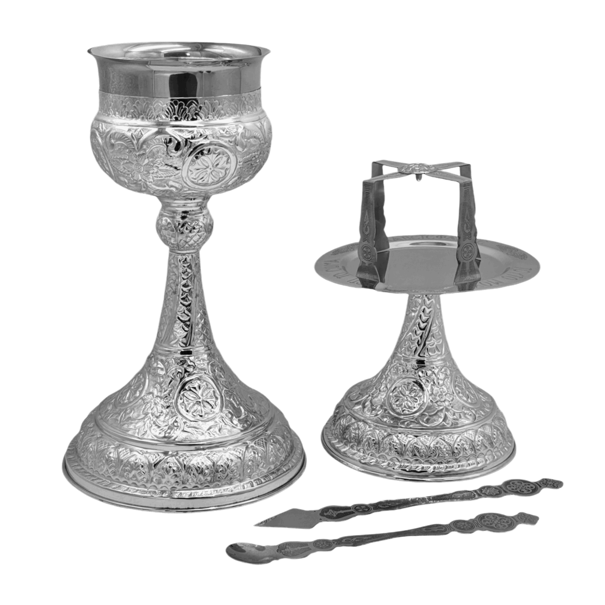 Intricate silver church items including a chalice, candle holder, and liturgical spoon, designed for Orthodox Christian religious ceremonies and church services.