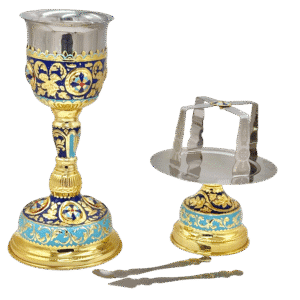 Intricately decorated silver and gold ecclesiastical chalice and stand with blue enamel, used in Orthodox Christian church services for Holy Communion.