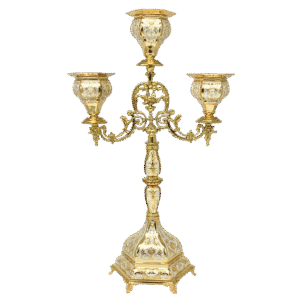 Intricate gold ecclesiastical candelabrum with three ornate candle holders, used in church services and religious ceremonies. Elegant design with detailed craftsmanship, highlighting traditional Orthodox liturgical accessories.