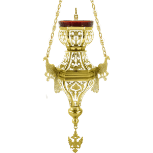 Ornate gold hanging oil lamp used in Orthodox church services, featuring intricate designs and chains, symbolizing devotion and religious tradition.