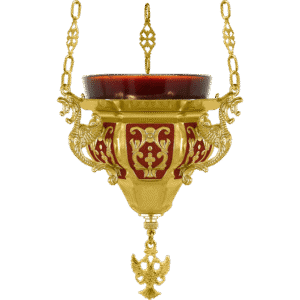 Golden hanging oil lamp with ornate church decoration, traditional religious liturgical item, religious church artifact, brass religious lamp for church ceremonies.