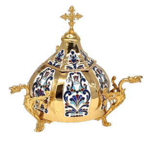 Intricate gold and enamel ecclesiastical vessel with detailed religious design, used for church ceremonies.